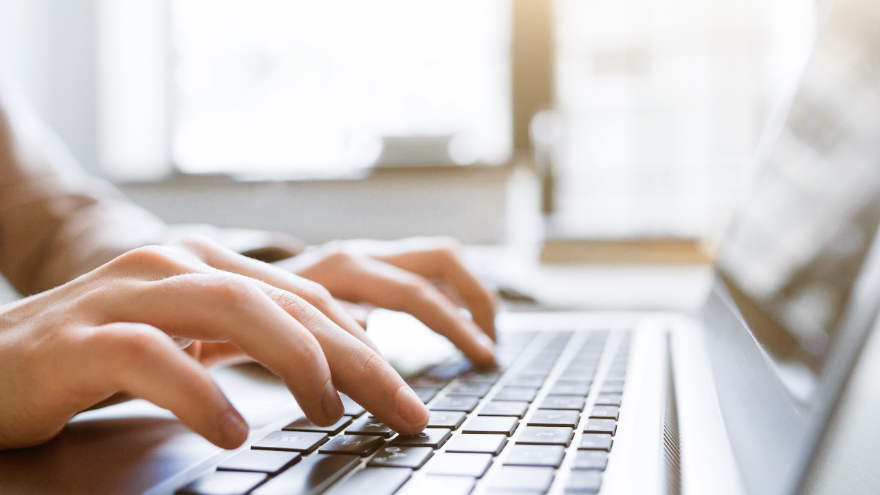 Freelance technical writer: Close-up of hands at laptop